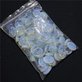 Macro shot of 13x18mm oval opal stones with blue-orange flashes on dark background - Opal (Synthetic) (1 Piece)