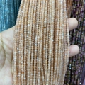 Detailed view of faceted 2-3mm light orange natural stone beads for jewelry making - Sunstone B 1 Strand
