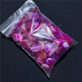 Detailed view of polished oval agate stones in vibrant purple and pink with natural banding - Deep Rose Red Agate