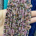 Macro view of 2-3mm faceted multi-color tourmaline beads strand held by hand - Tourmaline 1 Strand