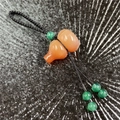 Orange agate gourd keychain with hand-woven black cord and green decorative beads - Red Agate