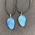 Set of two opalite skull pendants on black cords with fine facial carvings - Opalite (Synthetic)