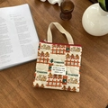 Bolso acolchado navideño con motivos de jengibre y cremallera roja sobre madera - Muñecas