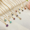 Star-shaped natural stone pendant necklaces in assorted colors on a textured background - Random