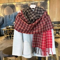 Classic red and black plaid scarf with fringe tassels worn over a grey wool coat - Red & Brown Plaid