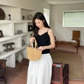 Minimalist khaki woven straw tote bag with double handles shown in a lifestyle setting - Small / Khaki