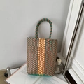 Handwoven PVC basket bag featuring green brown and yellow striped colorblock design - Orange Green and Yellow