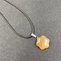 Star-shaped orange flower pendant necklace with obsidian agate texture and black cord - Red Agate