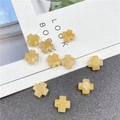 Detailed view of faceted yellow cross-shaped stone beads for DIY jewelry making - Topaz