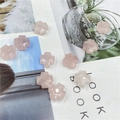 Gefacetteerde roze kwarts kruiskralen voor DIY sieraden maken op een tijdschrift achtergrond - Rozenkwarts