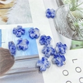 Close-up of blue and white stone cross beads for DIY jewelry making and crafts - Blue Spot Stone