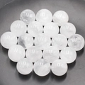 Polished 16mm natural clear quartz sphere with internal texture on dark tray - White Crystal