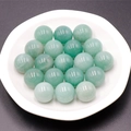 Green Aventurine natural stone spheres 16mm polished round beads in a white ceramic dish - Green Aventurine