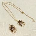 Golden wire-wrapped tiger eye crystal necklace set on textured fabric background - Tiger Eye (Brown Chips)