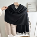 Solid black tassel scarf in premium cashmere-feel fabric styled on a beige coat - No.25 Black