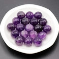 Polished 16mm natural purple amethyst round beads displayed on a white tray - Amethyst