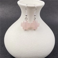 Pink quartz crystal cross earrings with silver hooks on white ceramic holder - Rose Quartz