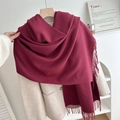 Solid burgundy tassel scarf draped over an elegant coat for a minimalist winter style - No.21 Wine Red