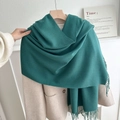 Solid deep green thick scarf with decorative tassels worn over a cream winter wool coat - No.16 Emerald Green