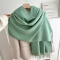 Mint green fringe scarf made of soft cashmere-like fabric styled on a beige wool coat - No.12 Bean Green