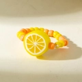 Macro shot of handmade beaded ring featuring a yellow resin lemon slice and colorful beads - Yellow Lemon Style (31025-ring-oy)
