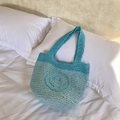Handmade crochet mini tote bag with blue patchwork and yellow smiley face design - Blue