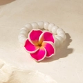 Close-up of a vibrant pink plumeria flower ring with white beads on a stone surface - Pink Gradient Plumeria Style (29919-ring-ros)