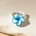 Close-up of a white beaded elastic ring featuring a blue frangipani flower detail - Blue White Gradient Plumeria Style (29919-ring-blu)