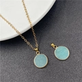 Golden chain necklace featuring a round light blue stone pendant with gold-plated edges - Aquamarine