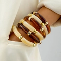 Retro acrylic tube bracelet set with amber resin beads and gold accents on model - Amber Tortoise Gold Combination
