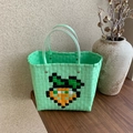 Handwoven green plastic tote bag with orange pixel carrot design and clear handles - Pixel Carrot Style / Green