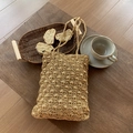 Elegant gold woven tote bag featuring a textured wave pattern for a summer vacation look - Gold