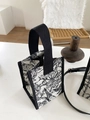 Detail of floral canvas tote showing refined embroidery and reinforced black handle - Mini Size