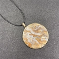 Round natural stone pendant necklace with gold trim and white and brown marble texture - Crazy Lace Agate