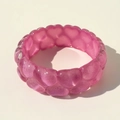 Detailed view of pink translucent resin bracelet featuring 3D embossed heart patterns - Lavender