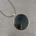 Minimalist round black stone pendant with gold rim and black cord necklace - Obsidian