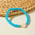 Sky blue faceted crystal bead bracelet with a white clover shell pendant and gold accents - Blue