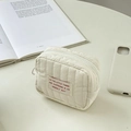 Mini cream quilted cosmetic bag for lipstick with elegant zipper on white desk - Off White