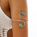 Detailed view of silver spiral arm cuff with turquoise beads on model's upper arm - Silver-Turquoise