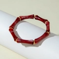 Detailed close-up of dark red bamboo-shaped acrylic beads with golden metal spacers - Dark Red