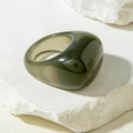 Macro detail of a minimalist translucent smoky gray resin ring on a textured stone base - Smoky Grey(31761)