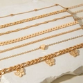 Detail of 7pcs gold butterfly and heart layered anklet set on textured stone - Gold Butterfly Heart 7Pcs Set (30960-ank-G-EP)