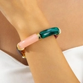 Close-up of colorful resin bead bracelet with gold metal spacers on model wrist - Bamboo Tube Spliced (31735-bra-colour)
