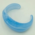 Close-up of light blue translucent acrylic cuff bracelet with marble texture - Light Blue/Cloud Blue