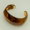 Detailed view of retro amber tortoiseshell acrylic open cuff with thick rounded geometry - Amber Brown/Tortoiseshell