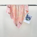 Floral and cheetah print silk scarf in pink and orange tones hanging on metal bar - Pink