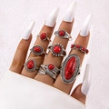 Close-up of bohemian silver alloy ring set with carved feathers and red stones - Retro Red Stone Feather Style (6225-red)
