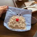 Detail of blue plaid cosmetic bag with 3D fuzzy monster patch and metal zipper - Puppy Blue Plaid