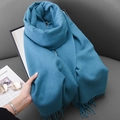 Elegant blue cashmere-feel scarf with fringes on a premium textured leather surface - Lake Blue