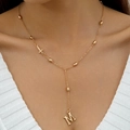 Close-up of a gold layered Y-necklace with M initial pendant and small cross accent - Gold Initial M Cross Necklace (30731)